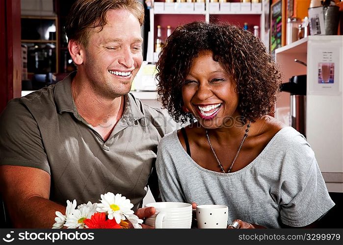 Mixed race couple in coffee house