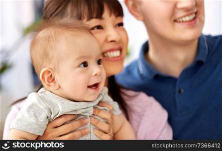 mixed-race family, parenthood and people concept - close up of happy mother and father with baby son. close up of happy mixed-race family with baby son