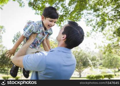 Mixed Race Father and Son Playing Together in the Park.
