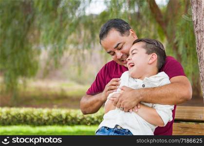 Mixed Race Hispanic and Caucasian Son and Father Having Fun At The Park