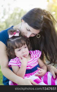 Mixed Race Loving Mother Consoles Her Crying Baby Daughter in Park.