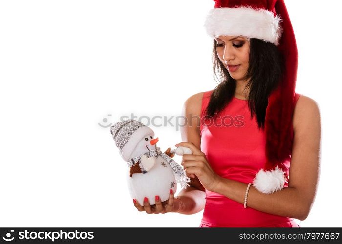 Mixed race woman in santa hat with little snowman.. Cute woman in santa claus hat holding little snowman. Attractive mixed race african girl isolated. Christmas season.