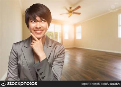 Mixed Race Young Adult Woman In Empty Room of House.