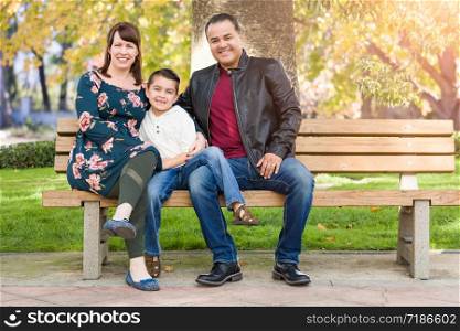 Mixed Race Young Family Portrait At The Park.
