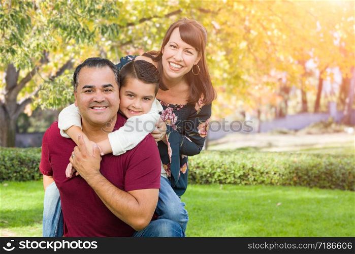 Mixed Race Young Family Portrait At The Park.