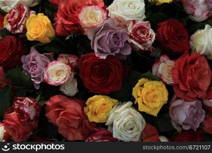 Mixed roses in a colorful bouquet with yellow, lilac, red and orange roses