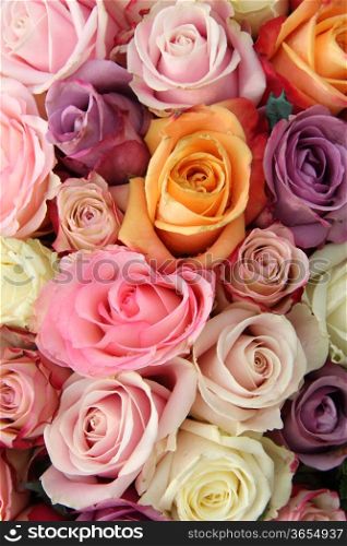 Mixed roses in various pastel colors in a wedding arrangement