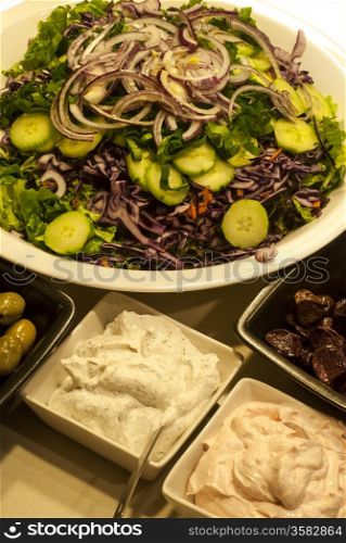 Mixed salad dish, olives, caviar roe spread