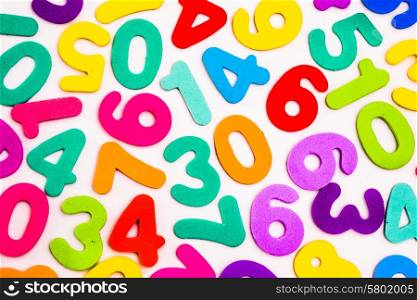 Mixed single digit numbers from one to nine, inluding zero, in many vibrant and bright colours.