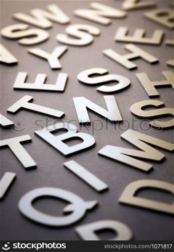 Mixed solid letters pile closeup photo. Education background concept. Mixed letters pile closeup photo
