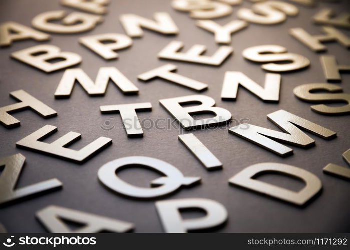 Mixed solid letters pile closeup photo. Education background concept. Mixed letters pile closeup photo