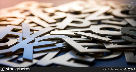 Mixed solid letters pile closeup photo. Education background concept. Mixed letters pile closeup photo