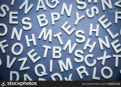 Mixed solid letters pile top view photo. Education background concept. Mixed letters pile top view photo