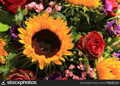 Mixed summer bouquet, sunflowers and roses in bright colors