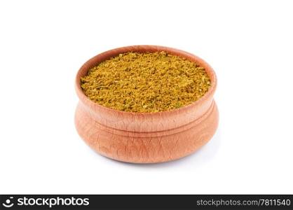 mixture of dry spices in a wooden salt-cellar on a white background