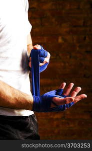 mma fighter is getting ready against brick wall