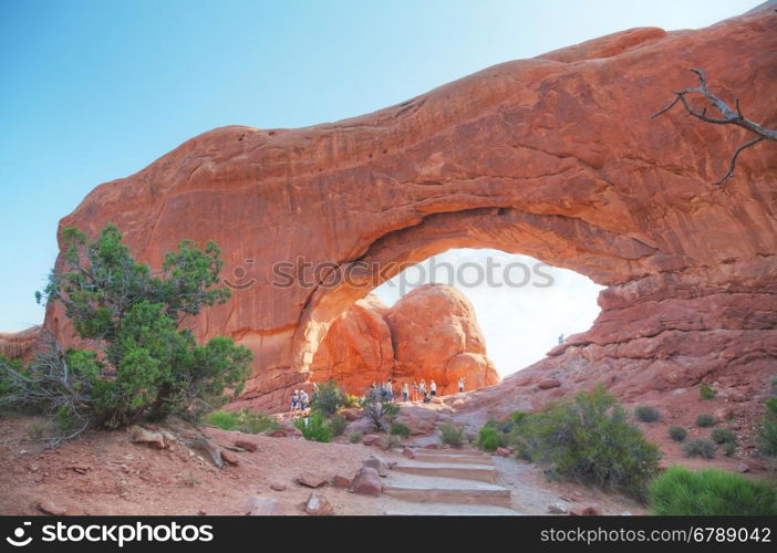 MOAB, UT - AUGUST 22: South Window Arches with people at the Arches National Park on August 22, 2016 near Moab, UT.