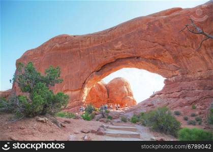 MOAB, UT - AUGUST 22: South Window Arches with people at the Arches National Park on August 22, 2016 near Moab, UT.