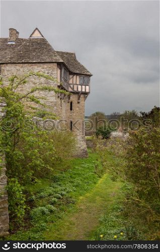 Moat around Stokesay castle on a dark cloudy day