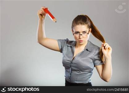 Mobbing at work, bad job relations concept. Angry mad bossy businesswoman being furious holding big pencil. Angry mad bossy businesswoman being furious