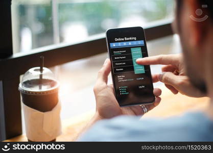 Mobile banking. Man using online banking technology on touch screen device. Financeial and investment. Digital and internet payments shopping on network connection. All on screen are design up.