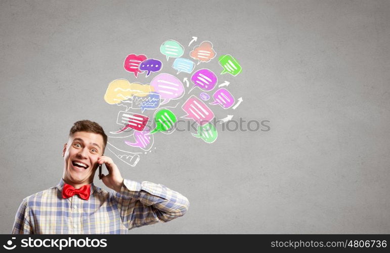 Mobile calls. Young man with mobile phone and colorful chat icons