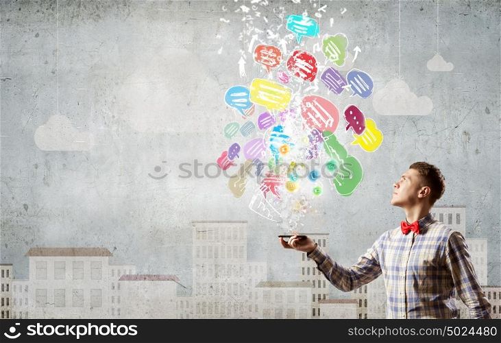 Mobile calls. Young man with mobile phone and colorful chat icons