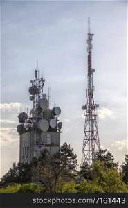 Mobile communication tower with control devices and antennas, transmitters and repeaters for mobile communications and the Internet