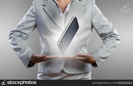 Mobile device. Close up of businesswoman presenting mobile phone