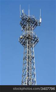 Mobile phone base station and antenna tower against the blue sky