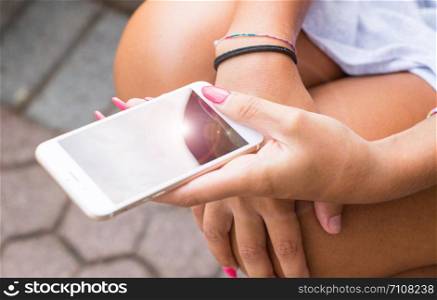 Mobile phone in a woman&rsquo;s hand