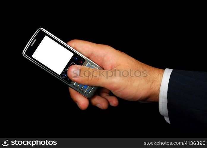 Mobile phone in hand isolated on black background with clipping path