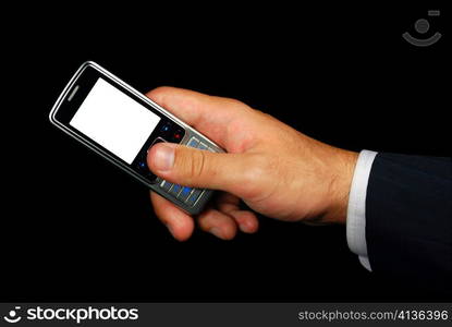 Mobile phone in hand isolated on black background with clipping path