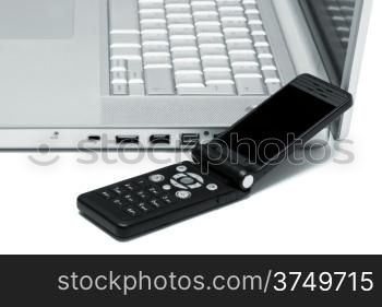 Mobile phone on the keyboard of a laptop