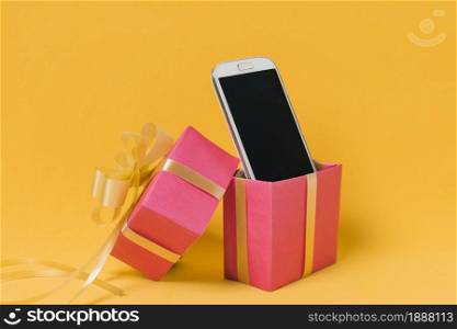 mobile phone with blank screen pink gift box . Resolution and high quality beautiful photo. mobile phone with blank screen pink gift box . High quality and resolution beautiful photo concept