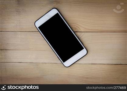 Mobile smartphone on wood background