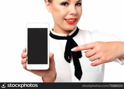 Mobile technology advertising concept image - elegant woman in formal business clothing with perfect fingernails holding smartphone with blank screen.