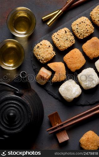 Mochi assortment with chopticks and tea traditional japanese rice dessert top view