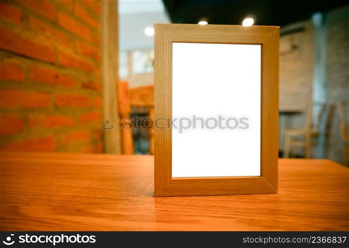 Mock up Menu frame standing on wood table in Bar restaurant cafe. space Menumack up blank for text marketing promotion