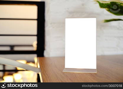 Mock up Menu frame standing on wood table in Bar restaurant cafe. space for text.