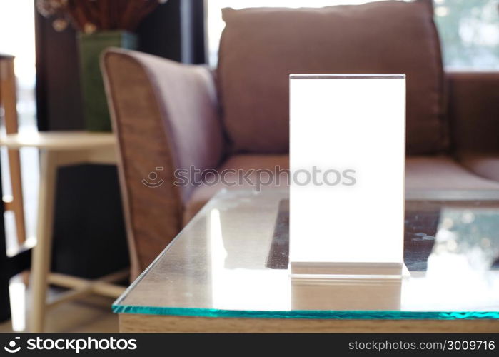 Mock up Menu frame standing on wood table in Bar restaurant cafe. space for text.