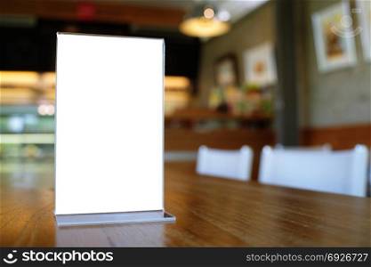 Mock up Menu frame standing on wood table in Bar restaurant cafe. space for text