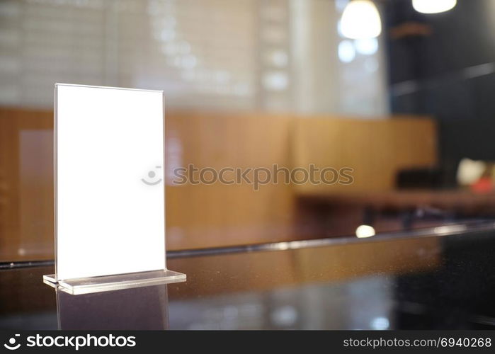 Mock up Menu frame standing on wood table in Bar restaurant cafe. space for text