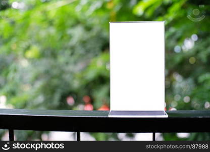 Mock up Menu frame standing on wood table in Bar restaurant cafe. space for text