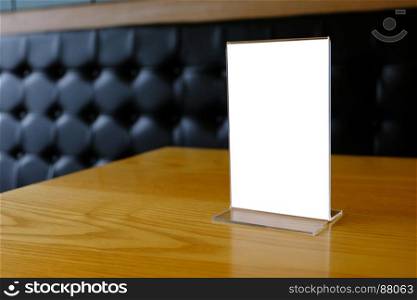 Mock up Menu frame standing on wood table in Bar restaurant cafe. space for text