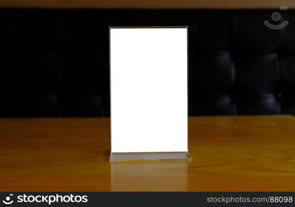 Mock up Menu frame standing on wood table in Bar restaurant cafe. space for text