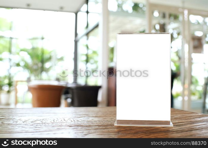 Mock up Menu frame standing on wood table in Bar restaurant cafe. space for text