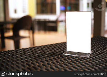 Mock up Menu frame standing on wood table in Bar restaurant cafe. space for text