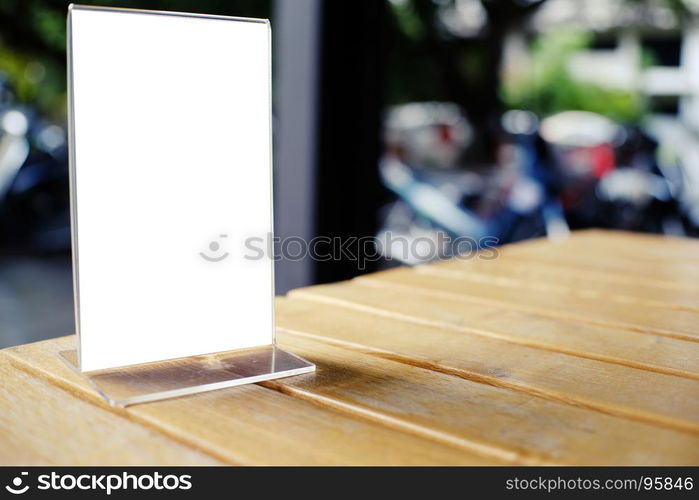 Mock up Menu frame standing on wood table in Bar restaurant cafe. space for text.