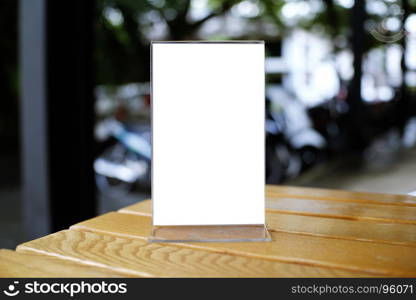 Mock up Menu frame standing on wood table in Bar restaurant cafe. space for text.